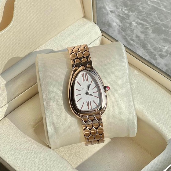 Bulgari snake watch with white dial and gold strap