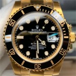 Rolex Submariner series, black dial, black bezel, 41mm, gold Oyster bracelet.