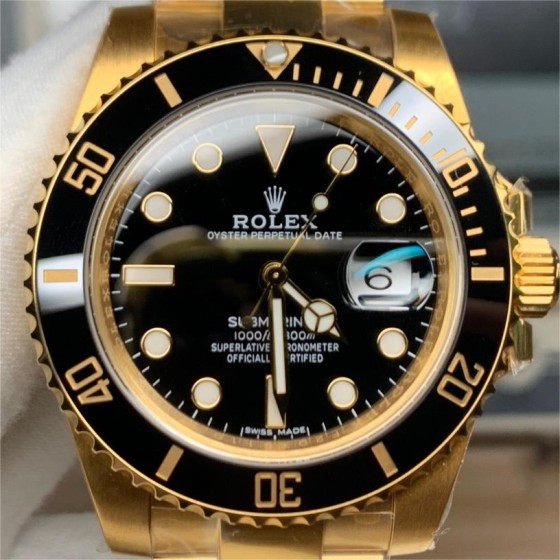 Rolex Submariner series, black dial, black bezel, 41mm, gold Oyster bracelet.