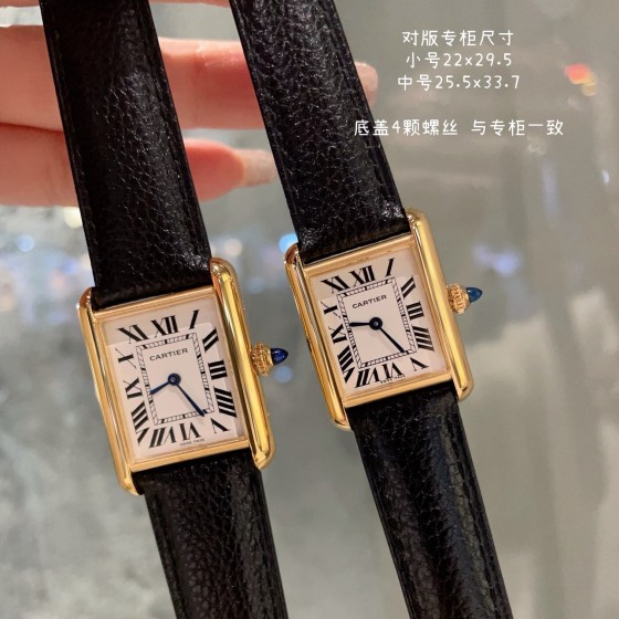 Cartier Tank watch, gold bezel, black leather strap.