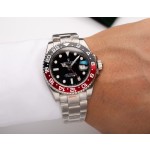 Rolex GMT-Master series, black dial, black and red bezel, 40mm, silver Oyster bracelet.