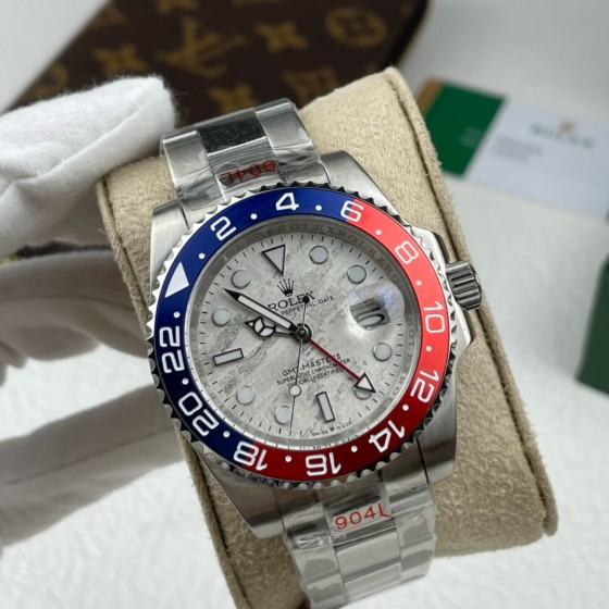 Greenwich series watch with meteorite-patterned dial, blue and red bezel, 40mm, and silver Oyster bracelet.
