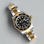 Rolex Submariner series, black dial, black bezel, 40mm, silver and gold Oyster bracelet.