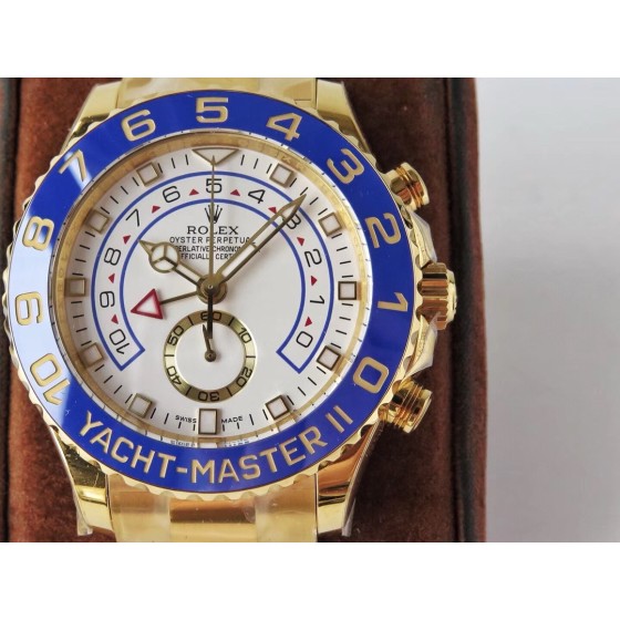 Rolex Yacht-Master series, white dial, blue bezel, gold case, 44mm, gold Oyster bracelet.
