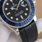 Rolex Yacht-Master series, black dial, blue bezel, silver case, 40mm, rubber strap.
