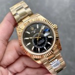 Navigator series men's watch with bright black dial, gold bezel, 42mm case, and gold Oyster bracelet.