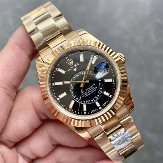 Navigator series men's watch with bright black dial, gold bezel, 42mm case, and gold Oyster bracelet.