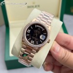 Sunday date display series women's watch with hematite-colored dial, diamond-set bezel, 36mm rose gold President-style bracelet.