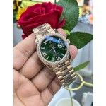 Sunday calendar series women's watch with diamonds, green dial, diamond-set bezel, 36mm, rose gold President-style bracelet.