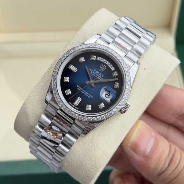 Sunday Calendar series women's watch with diamond-set gradient blue dial, diamond-set bezel, 36mm case, and silver President-style bracelet.