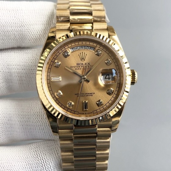 Sunday date display series women's watch with diamonds, gold dial, gold bezel, 36mm, gold President-style bracelet.