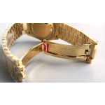 Sunday date display series women's watch with diamonds, gold dial, gold bezel, 36mm, gold President-style bracelet.