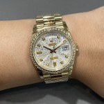 Sunday calendar series women's watch, silver dial, diamond-set bezel, 36mm, gold President-style bracelet.