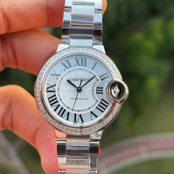 Cartier Ballon Bleu series, 33mm ladies' watch with silver dial and diamond setting, silver strap, mechanical movement.