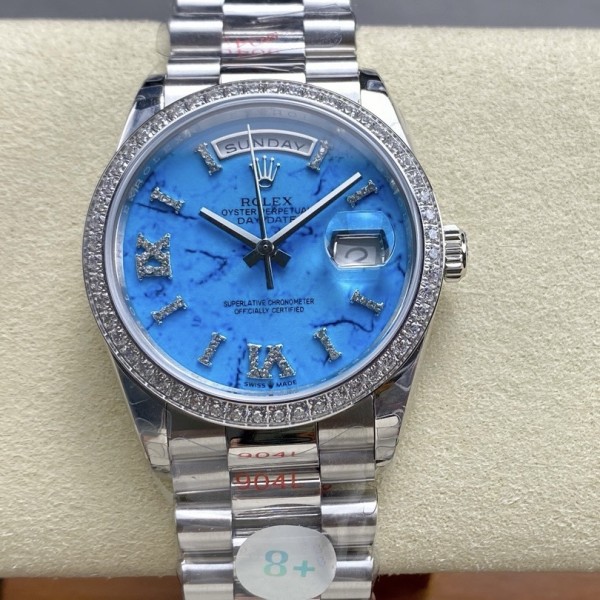 Sunday Calendar series women's watch, turquoise dial, diamond-set bezel, 36mm, silver President-style bracelet.