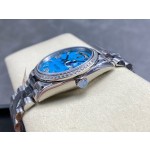 Sunday Calendar series women's watch, turquoise dial, diamond-set bezel, 36mm, silver President-style bracelet.