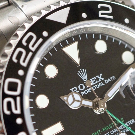 Rolex GMT-Master series, black dial, black bezel, 40mm, silver Oyster bracelet.