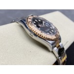 Yacht-Master series, black dial, rose gold bezel, 40mm, two-tone Oyster bracelet.