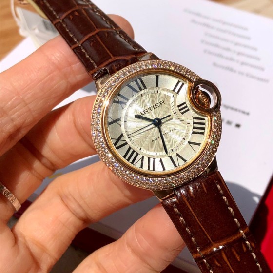 Cartier Ballon Bleu collection, 33mm ladies' watch with silver dial and diamonds, burgundy leather strap, mechanical movement.