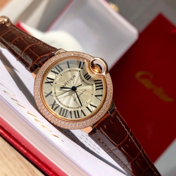 Cartier Ballon Bleu collection, 33mm ladies' watch with silver dial and diamonds, burgundy leather strap, mechanical movement.