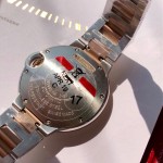 Cartier Ballon Bleu series, 33mm ladies' watch with silver dial and rose gold bezel, two-tone rose gold strap, mechanical movement.