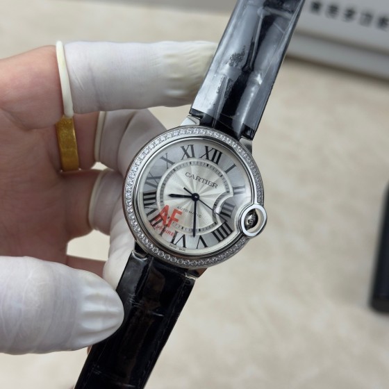 Cartier Ballon Bleu 36mm mechanical women's watch with silver dial, diamond-set bezel, and black leather strap.