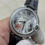 Cartier Ballon Bleu 36mm mechanical women's watch with silver dial, diamond-set bezel, and black leather strap.