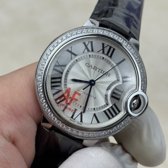 Cartier Ballon Bleu 36mm mechanical women's watch with silver dial, diamond-set bezel, and black leather strap.