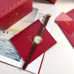 Cartier Ballon Bleu series, 33mm women's watch with silver dial and diamond-set bezel, brown leather strap, mechanical movement.