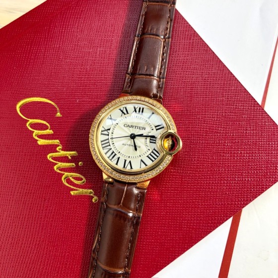 Cartier Ballon Bleu series, 33mm women's watch with silver dial and diamond-set bezel, brown leather strap, mechanical movement.