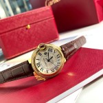 Cartier Ballon Bleu series, 33mm women's watch with silver dial and diamond-set bezel, brown leather strap, mechanical movement.