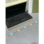 Four-leaf clover gold bracelet with rhinestones and blue accents