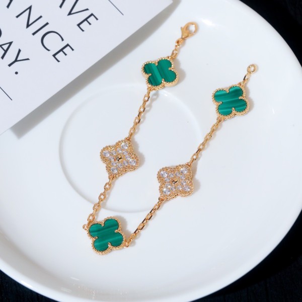 Four-leaf clover and peacock green enamel bracelet with interspersed rhinestones.
