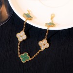 Four-leaf clover and peacock green enamel bracelet with interspersed rhinestones.
