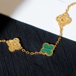 Four-leaf clover and peacock green enamel bracelet with interspersed rhinestones.