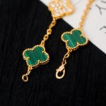 Four-leaf clover and peacock green enamel bracelet with interspersed rhinestones.