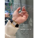 Cartier Tank watch, gold bezel, black leather strap.